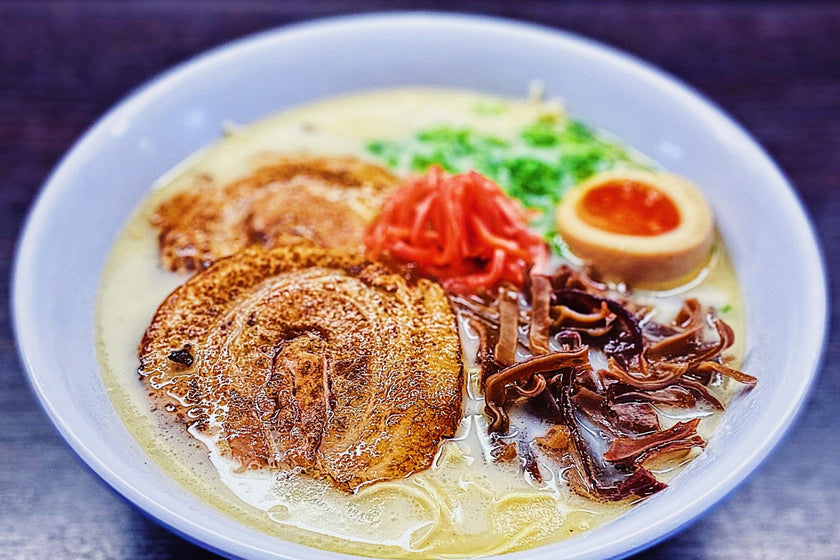 a finished bowl of classic tonkotsu with chashu, egg and kikurage